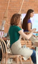 Group of people during classes in school of painters