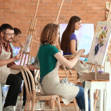 Group of people during classes in school of painters